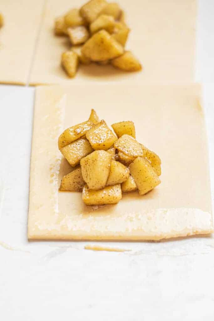 little pastry sheets with apple pieces.