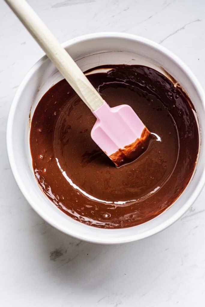 a bowl of chocolate with a rubber spatula.