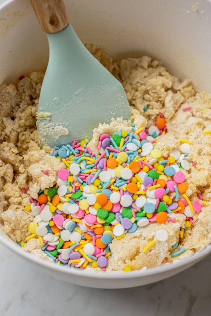 sprinkles in a bowl of cookie dough.