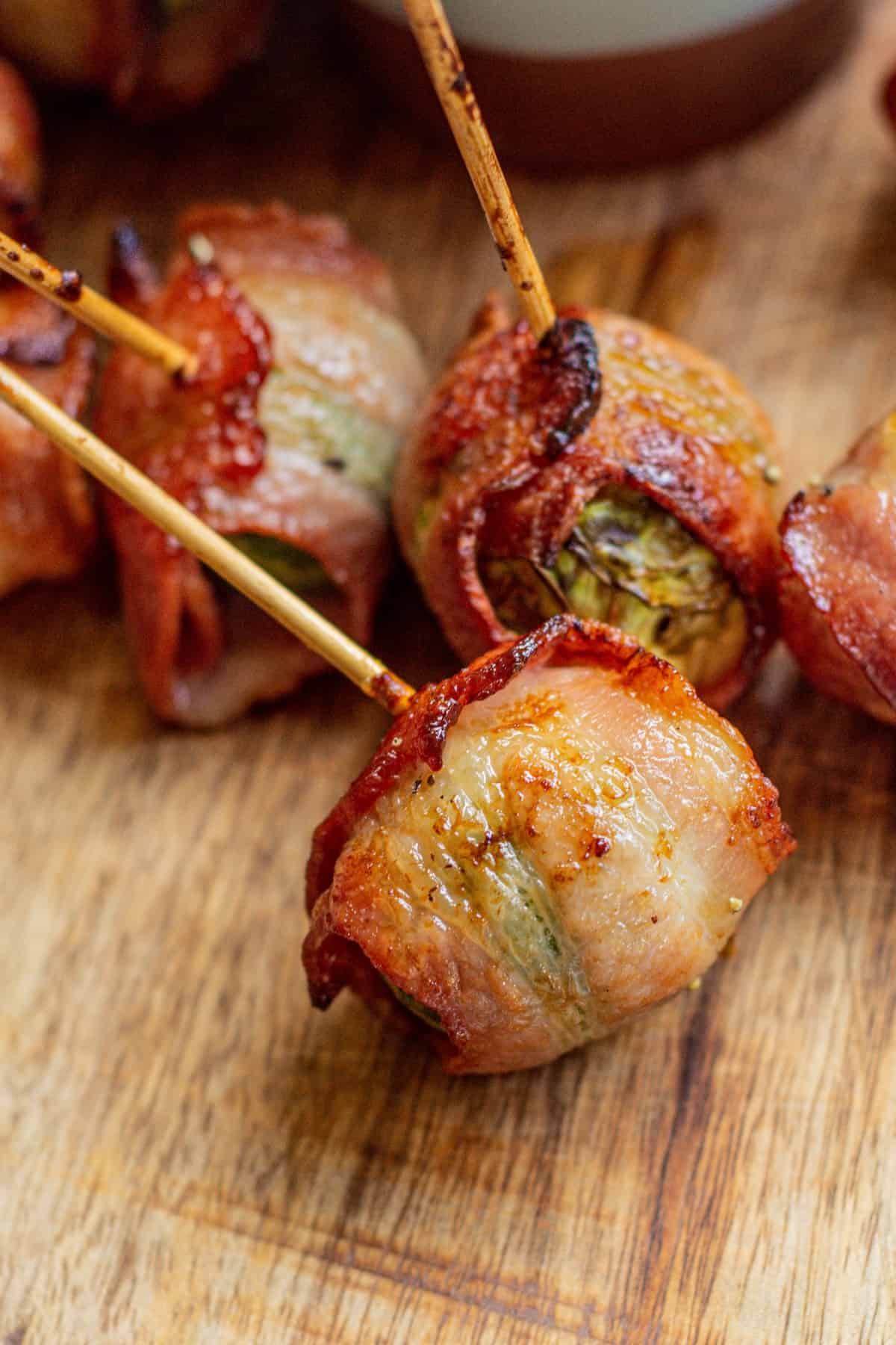 a bacon wrapped Brussel sprout on its side.