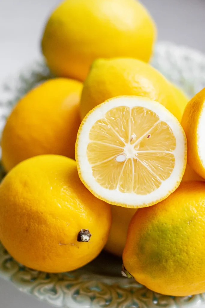 a cut lemon on top of other lemons.
